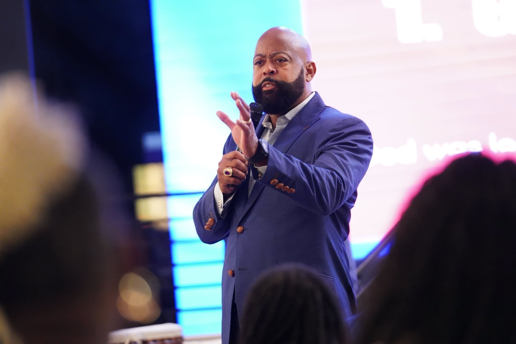 Bishop Dr. Richard Leaphart-Mack preaching with a microphone